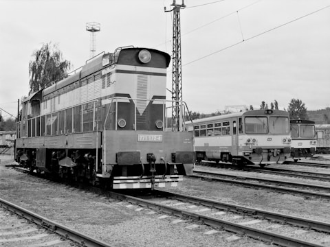 a black and white photo of a train on the tracks