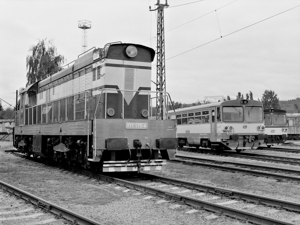 a black and white photo of a train on the tracks