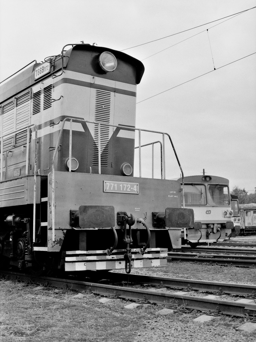 a black and white photo of a train on the tracks