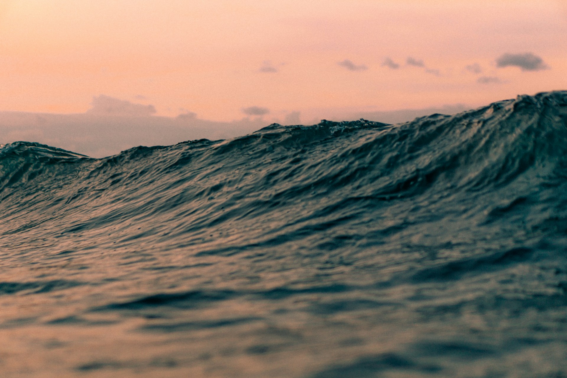 a person riding a surfboard on a wave in the ocean