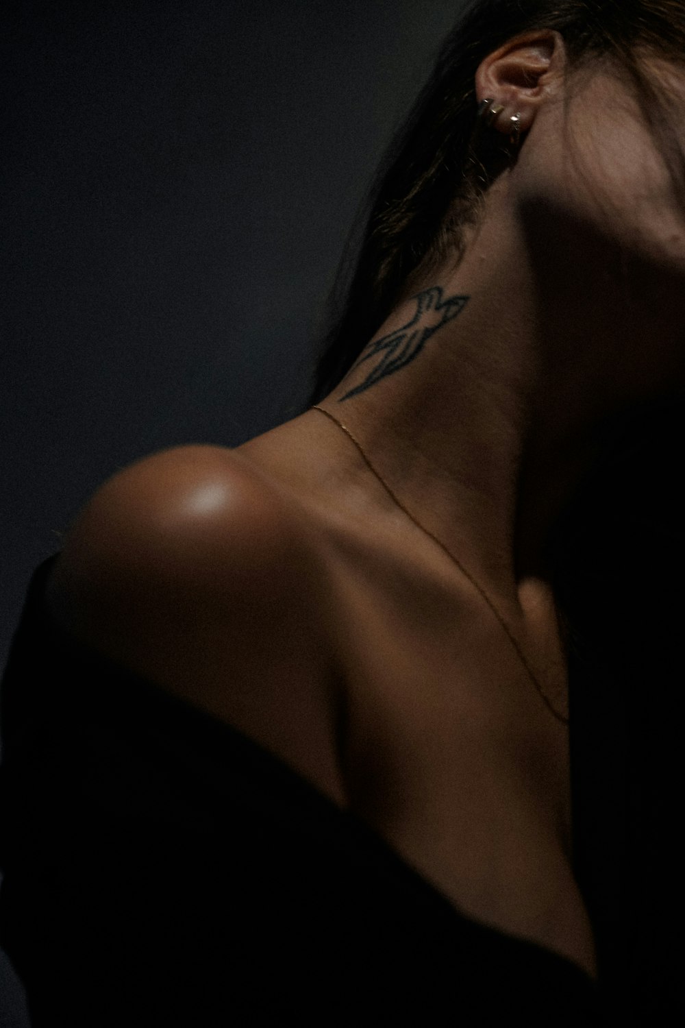 a woman with a tattoo on her neck