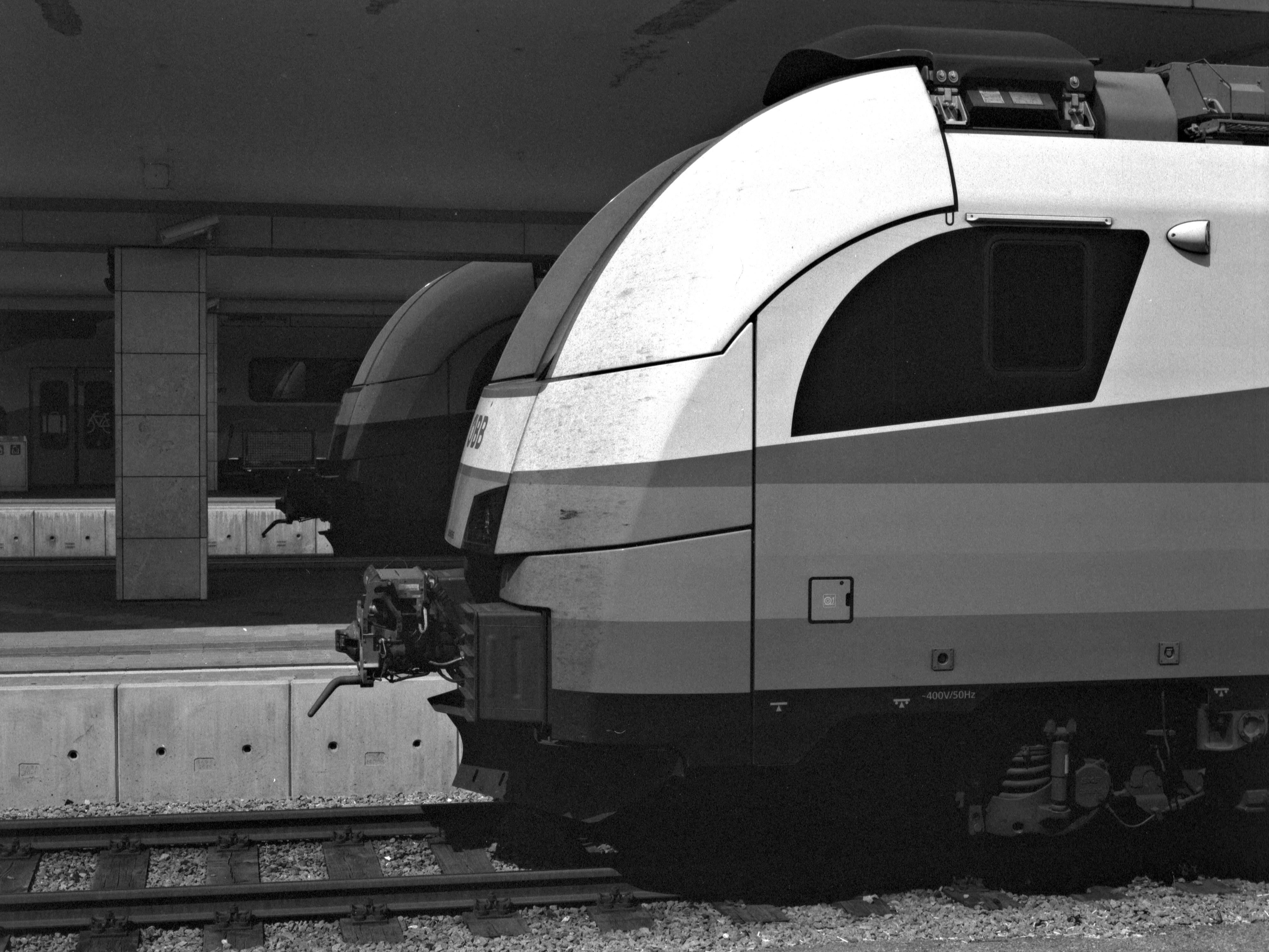 a black and white photo of a train at a station