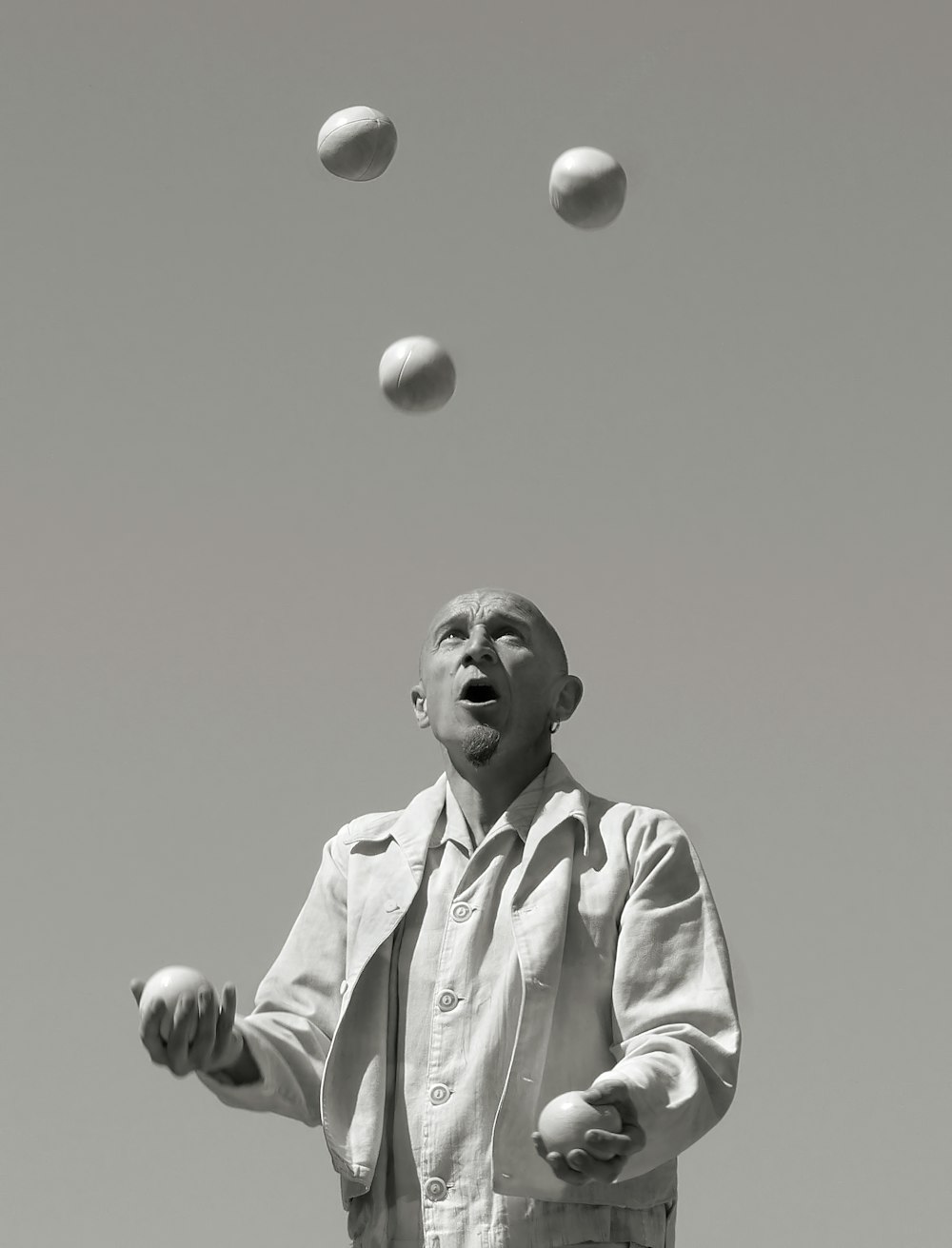 a man juggling balls into the air