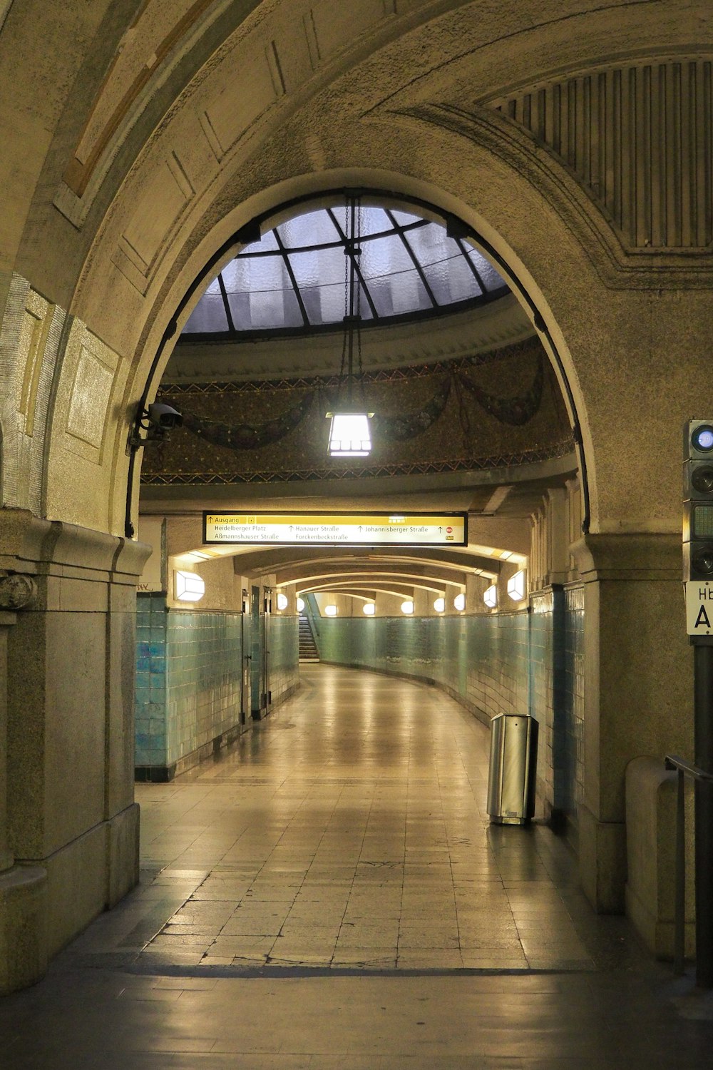 a subway station with a skylight and a tiled floor