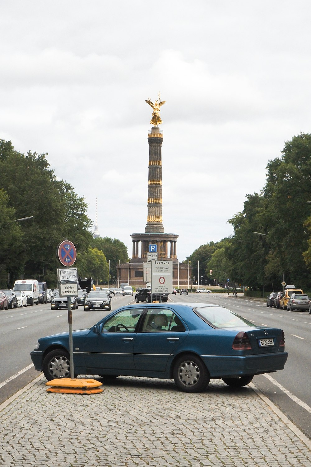 a blue car parked on the side of the road