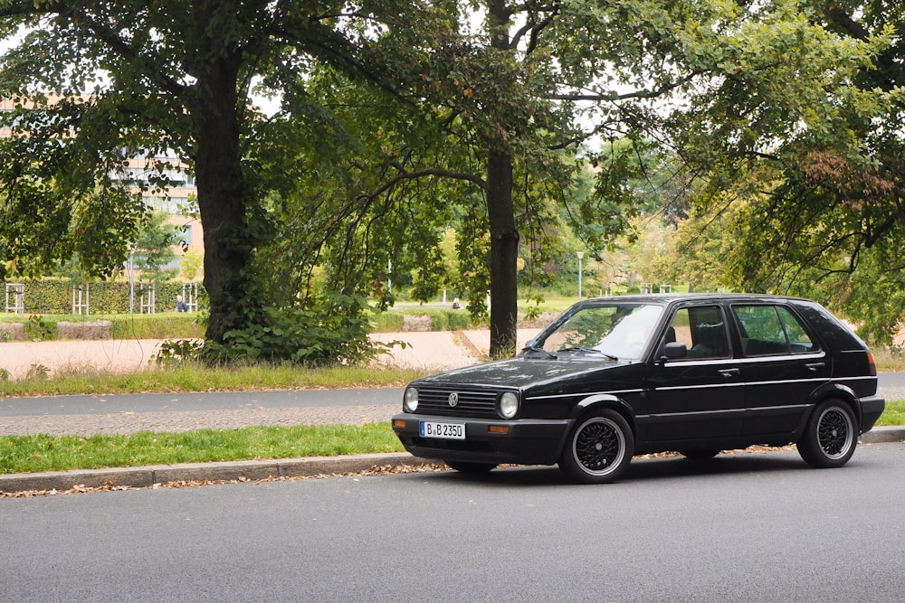 a black car parked on the side of the road