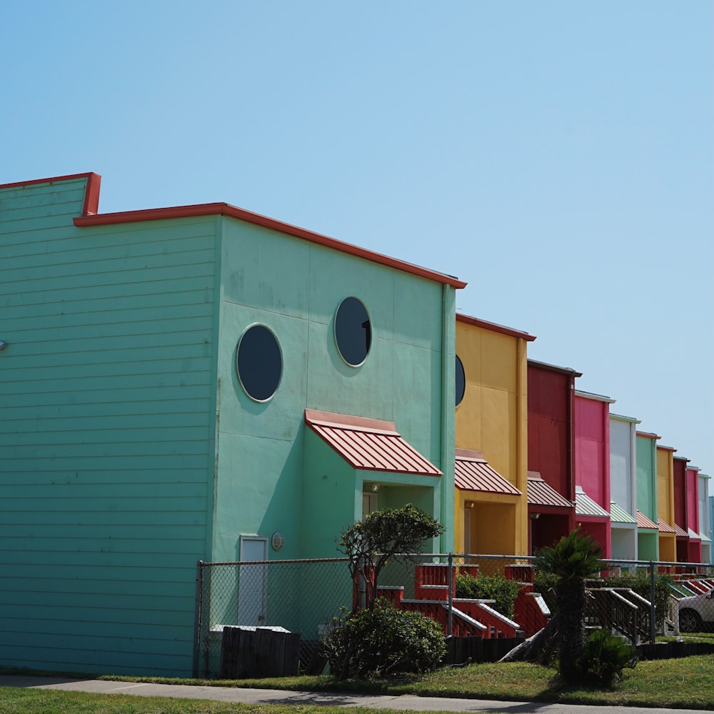 a row of multi - colored buildings with round windows