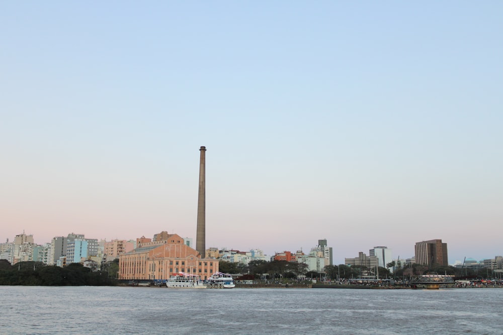 a large body of water with buildings in the background