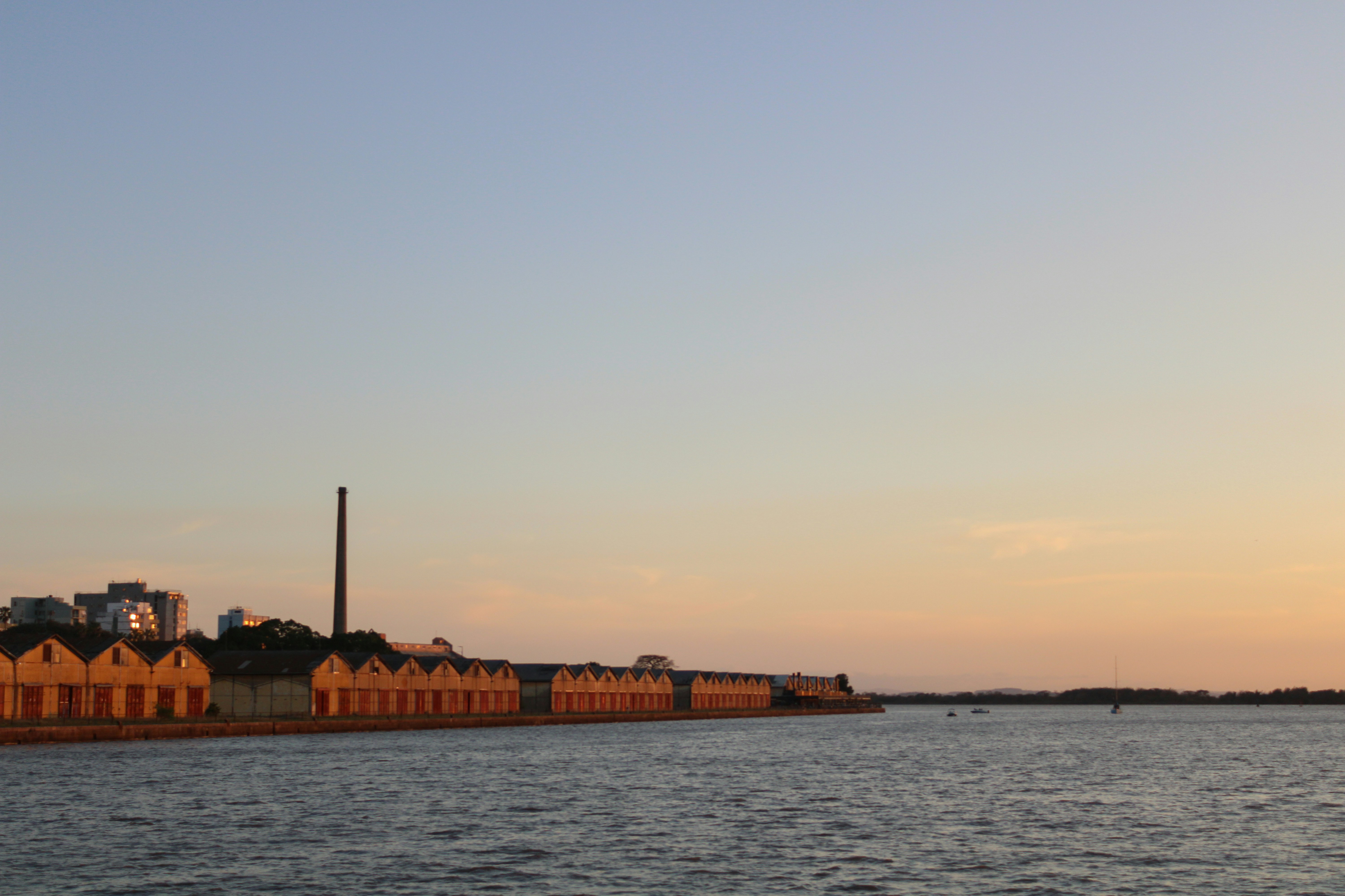 a large body of water with buildings in the background