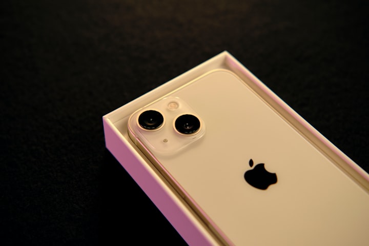 An iPhone 13 inside its open box