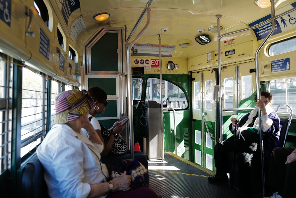 a group of people sitting on a bus next to each other