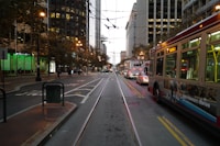 a city street filled with traffic next to tall buildings