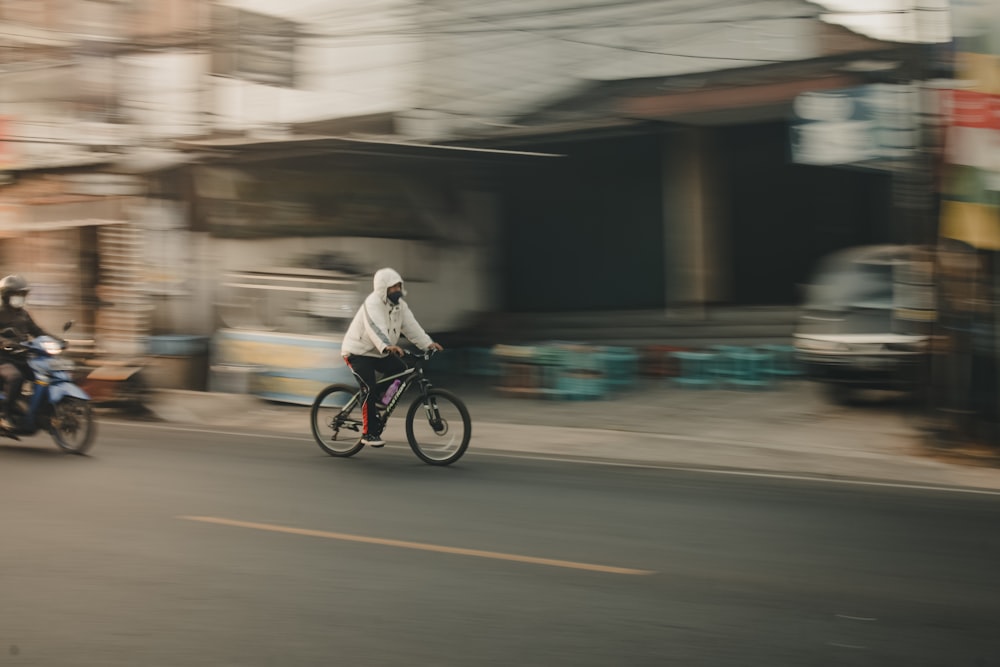a blurry photo of a person riding a bike down a street