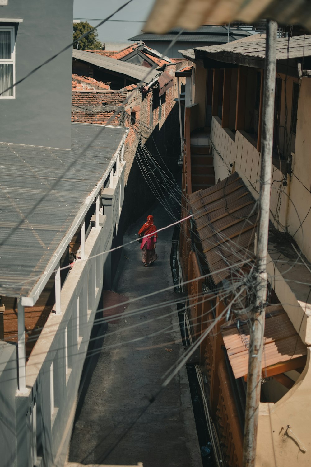 a person walking down a narrow alley way