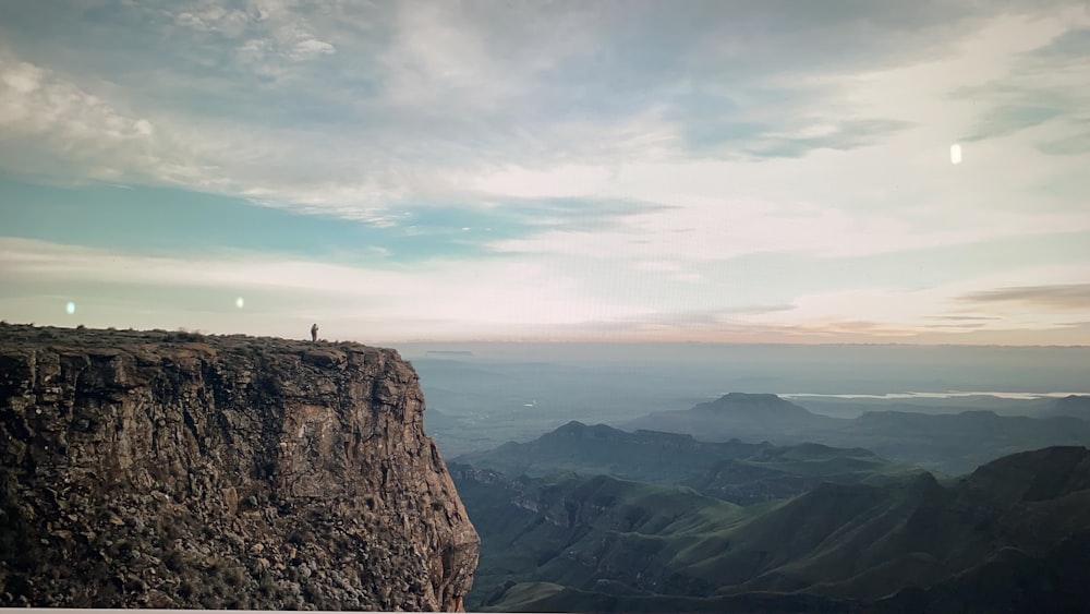 a person standing on top of a cliff