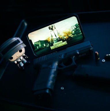 a toy gun and a cell phone sitting on a table