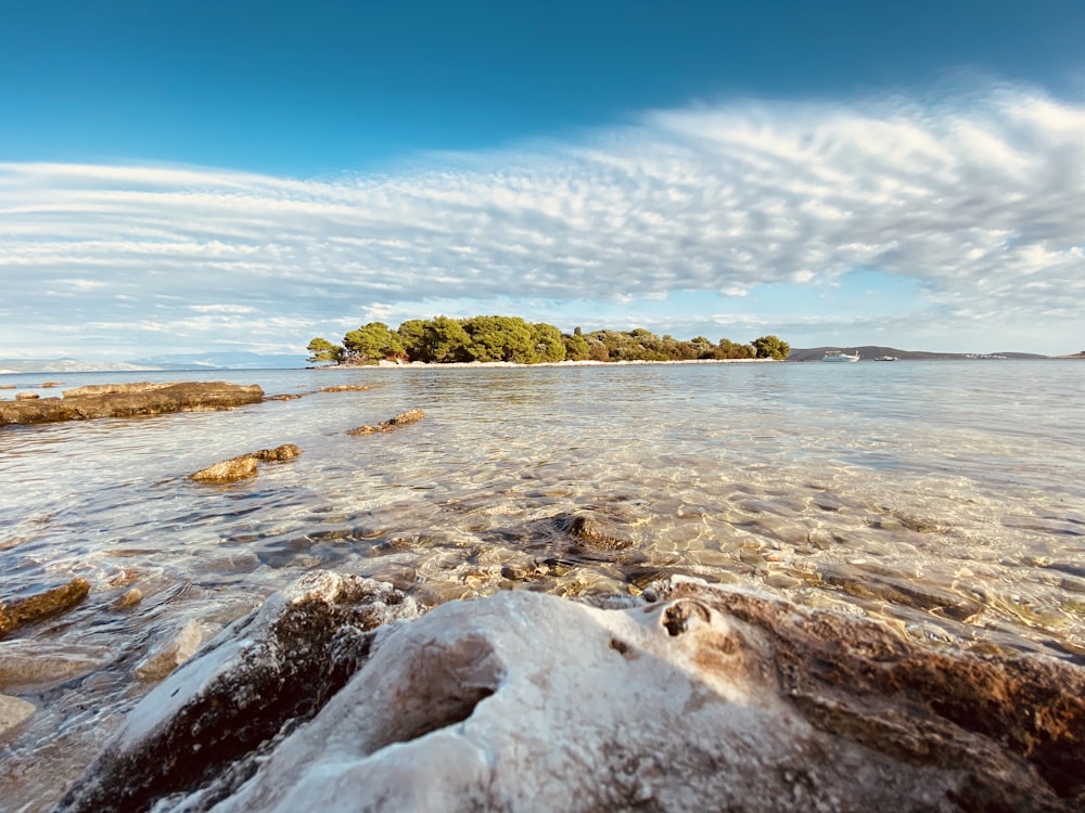 a body of water with a small island in the distance