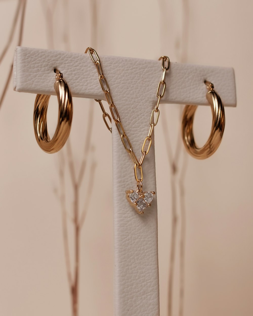 a close up of a pair of earrings on a stand
