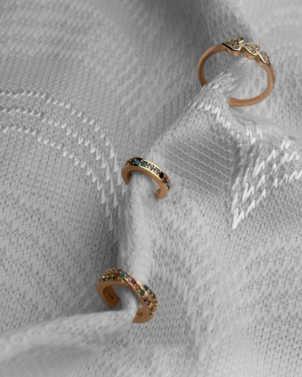 a pair of rings sitting on top of a white cloth