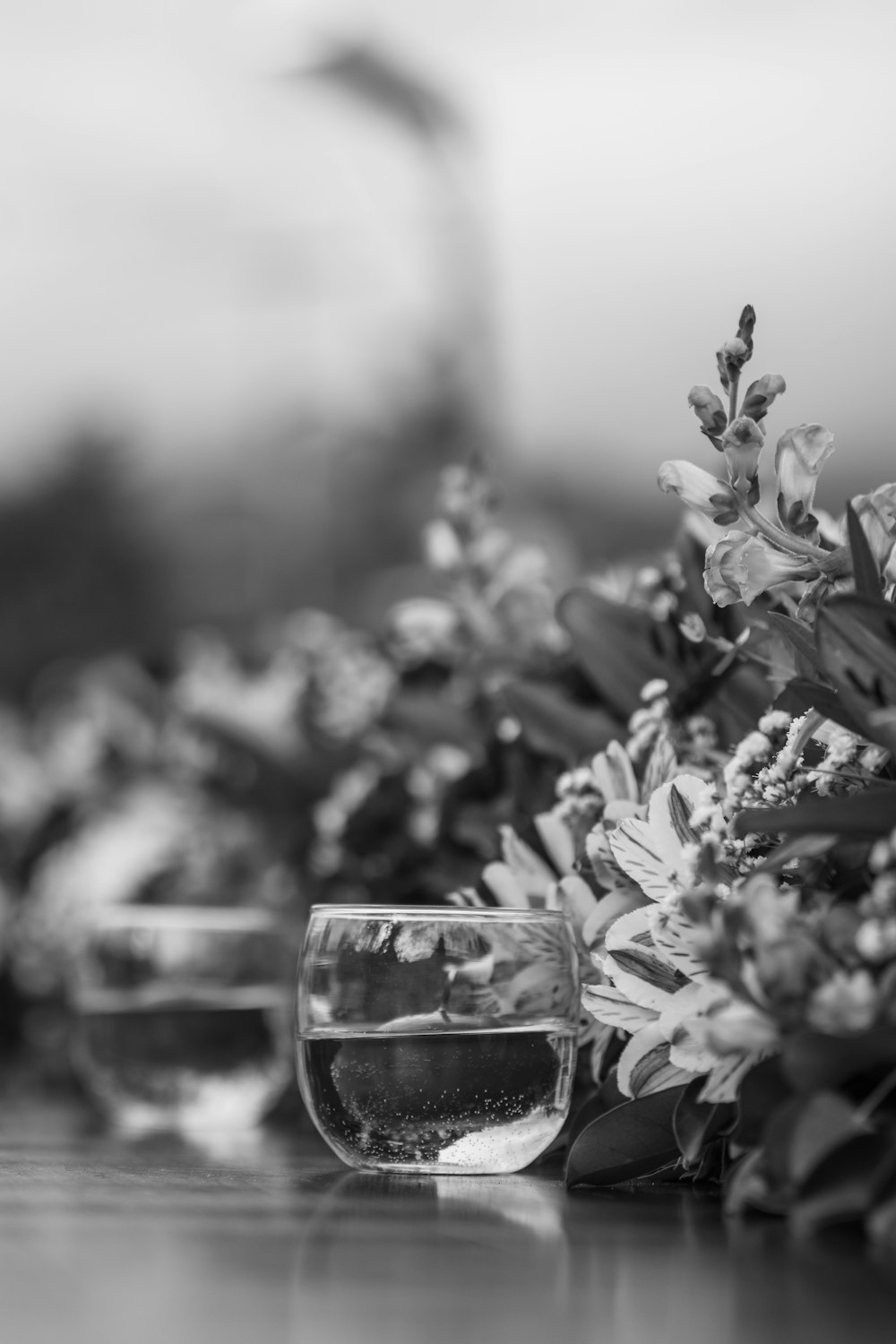 a glass of water sitting on top of a wooden table