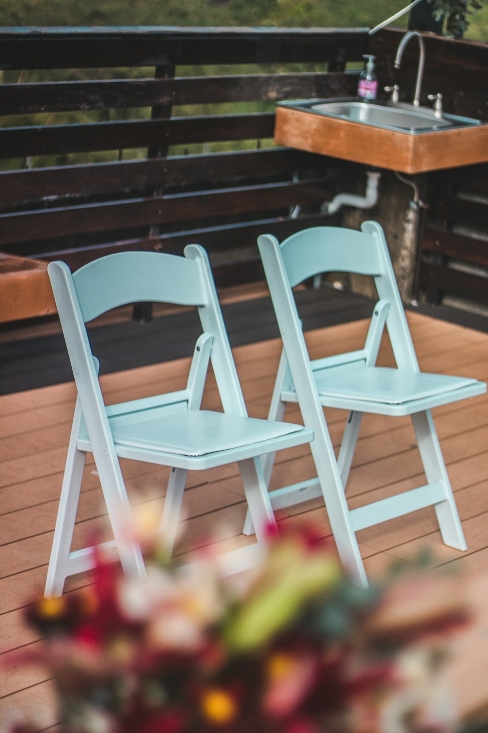 a couple of chairs sitting on top of a wooden deck