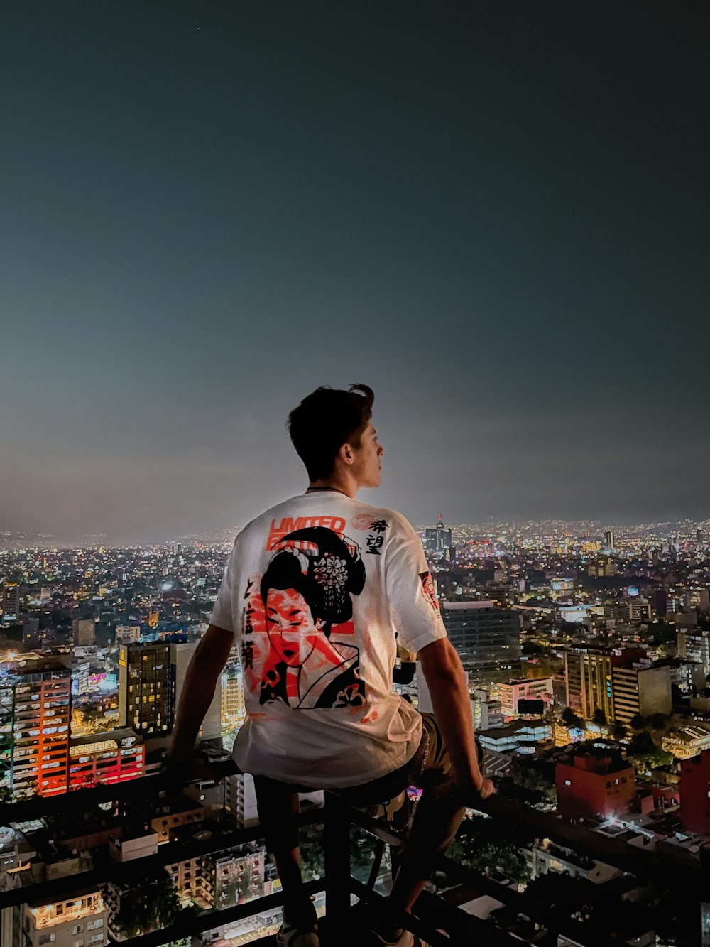 a man standing on top of a tall building