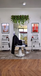 A sleek mobile barber station set up next to a car wash area.