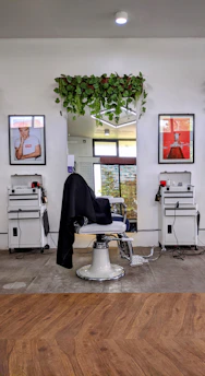 A sleek barber chair surrounded by polished tools in a cozy barbershop setting.