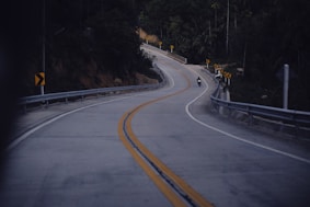 a motorcycle riding down a curvy road at night