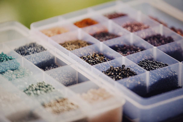 a plastic container filled with lots of different types of beads