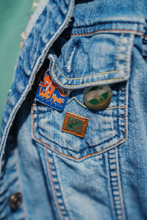 a close up of a person wearing a jean jacket