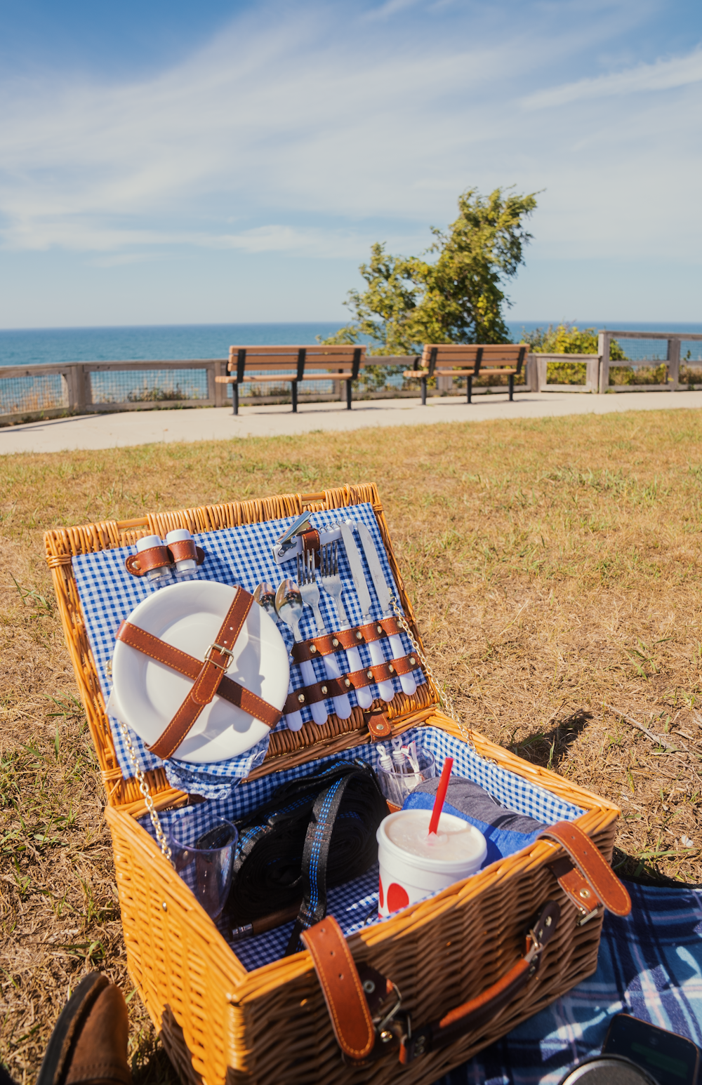 a picnic basket with plates and drinks in it