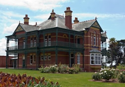 a large red brick building with green trim