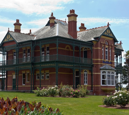 a large red brick building with green trim