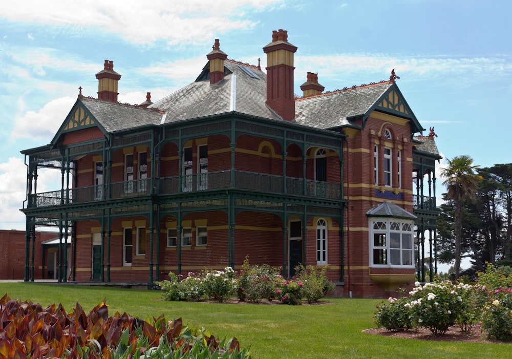 a large red brick building with green trim