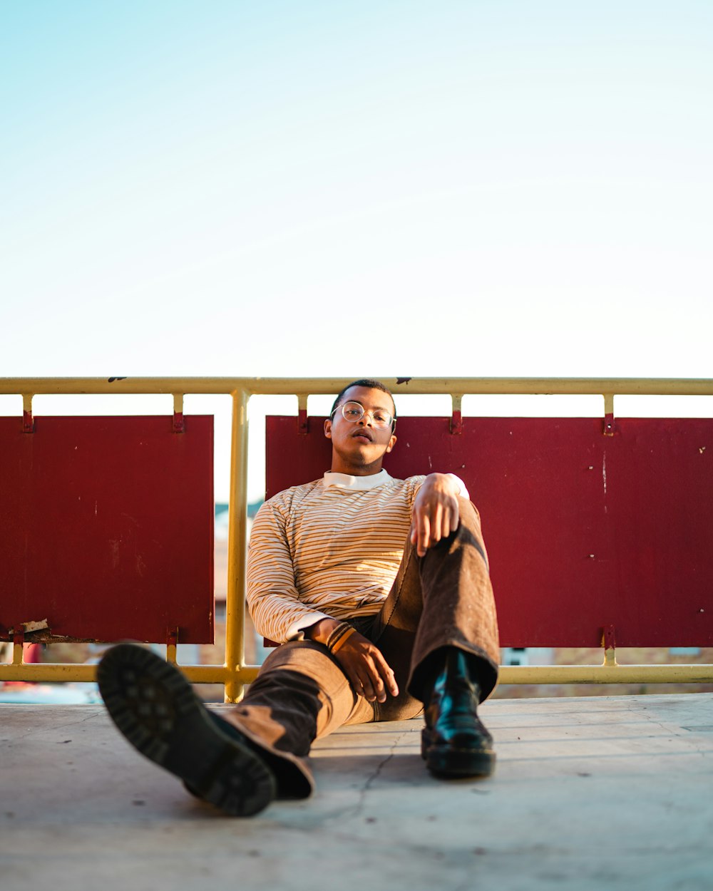 a man sitting on top of a wooden bench