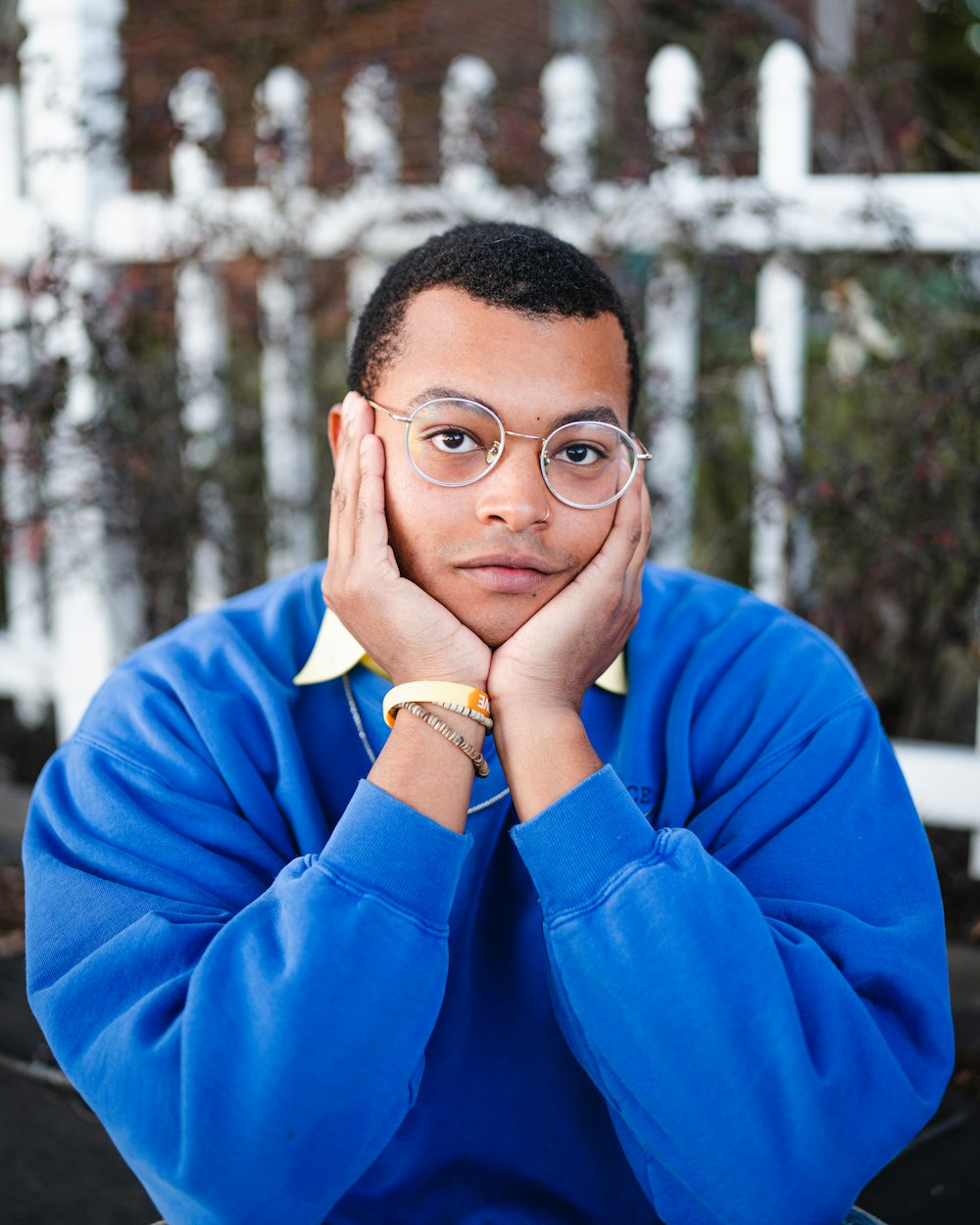 a man in a blue shirt is posing for a picture