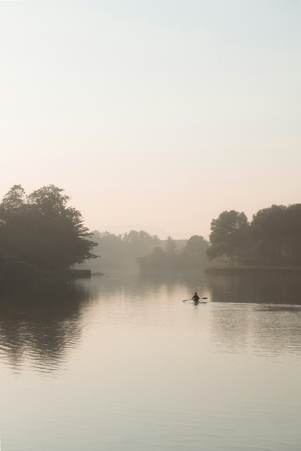 a person in a boat on a lake