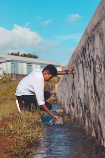Students conducting water quality tests by a local river during a hands-on science activity.