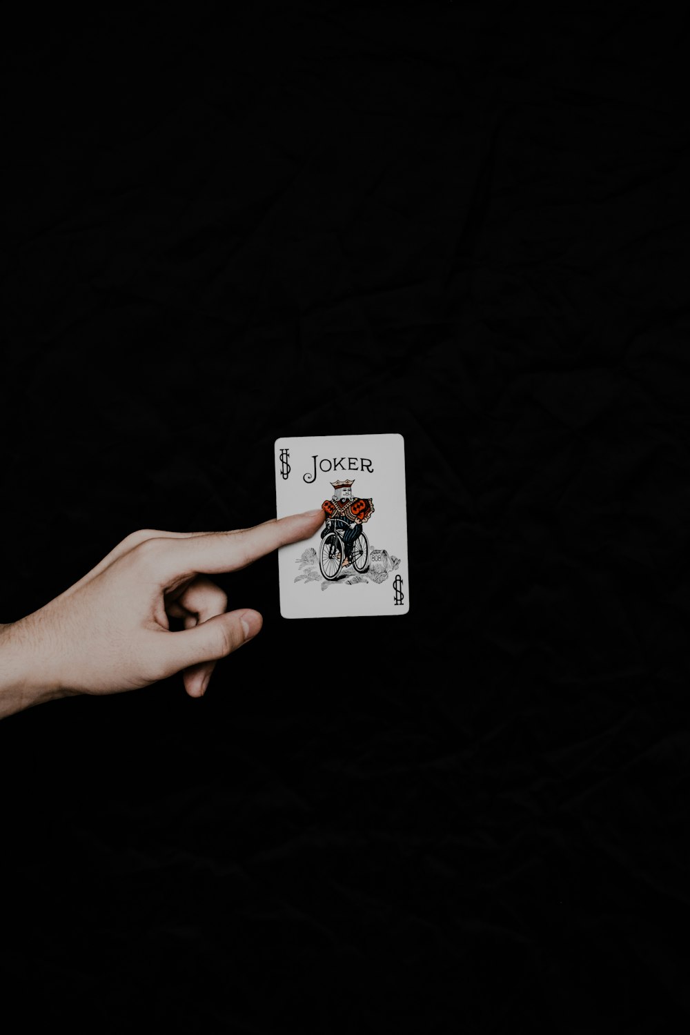 a person holding a playing card in their hand