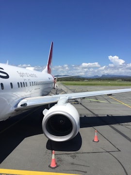 An airplane parked on a runway with clear blue skies.