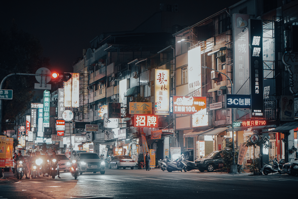 a city street filled with lots of traffic at night