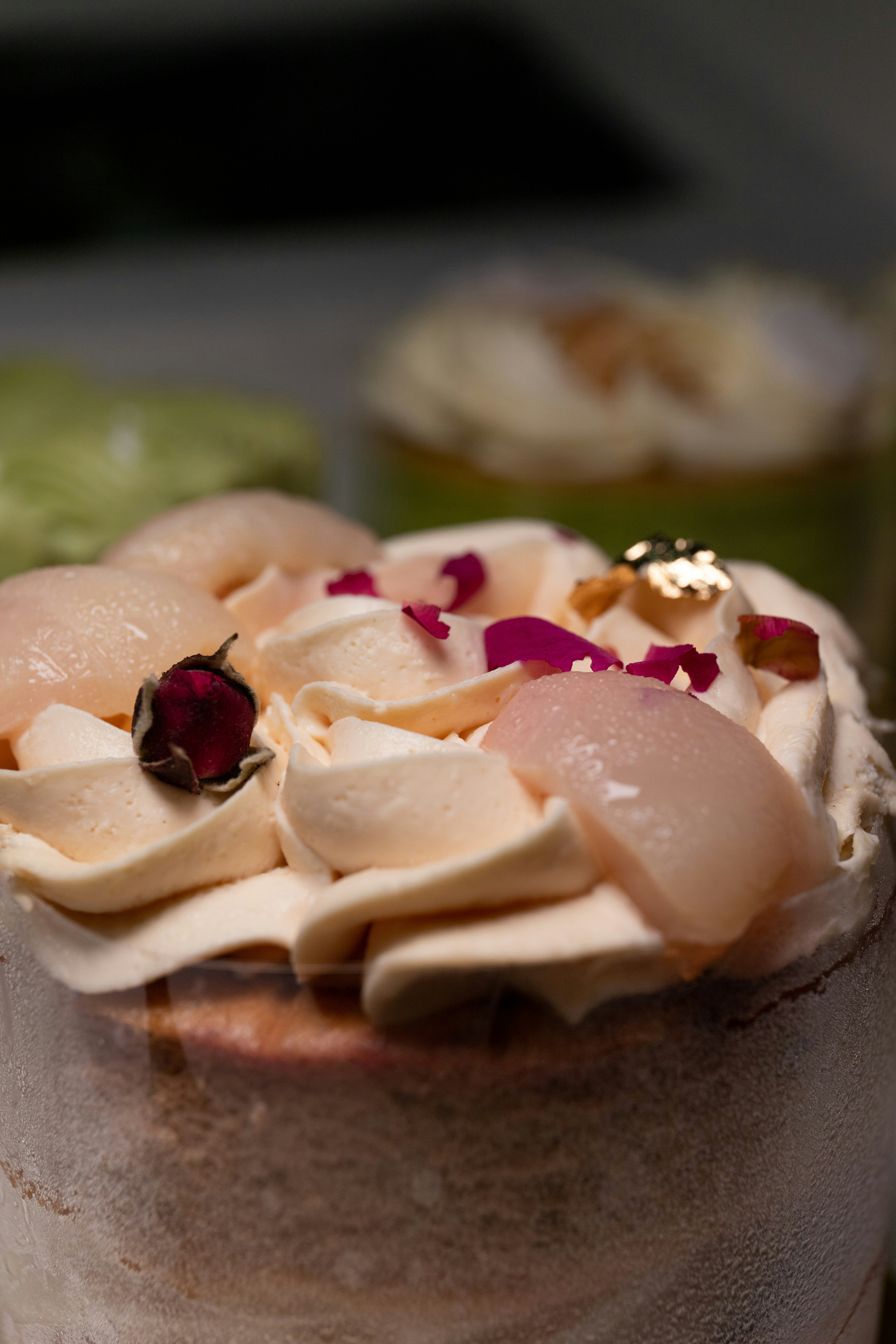 Elegant panna cotta dessert with rose petals and gold leaf on white plate, soft natural light