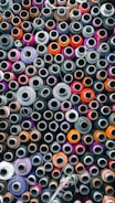 An array of different filament spools in various colors and textures.