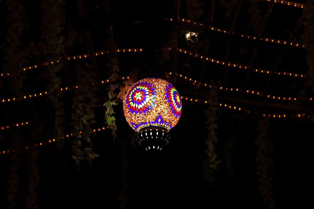a colorful light ball is lit up in the dark