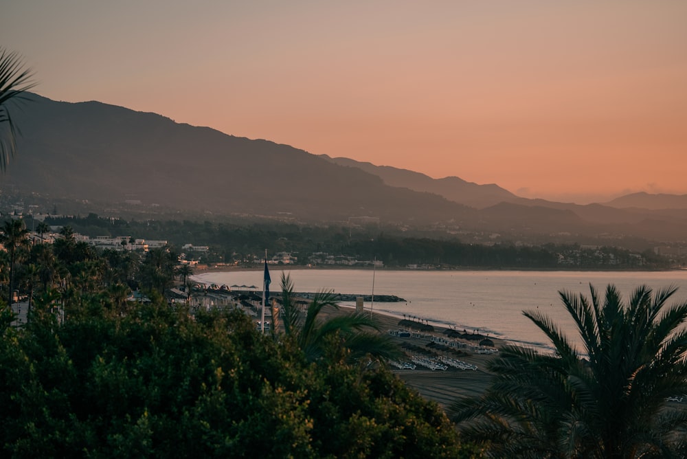 a view of a body of water with mountains in the background