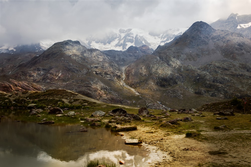 a mountain range with a lake in the foreground