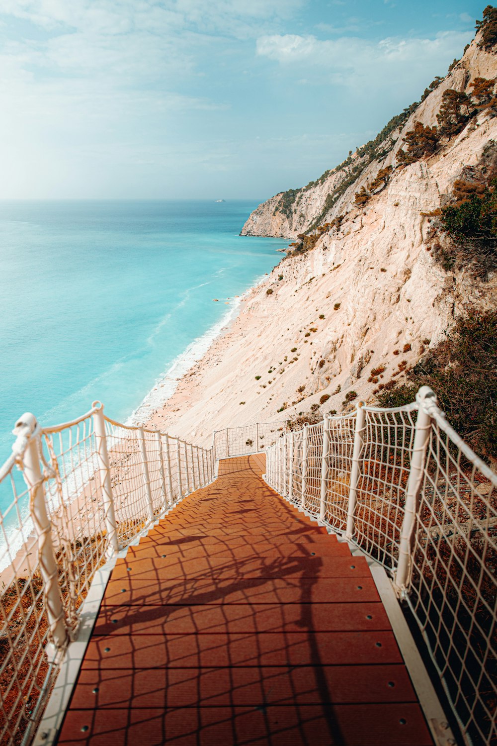 a stairway leading down to the beach with a view of the ocean