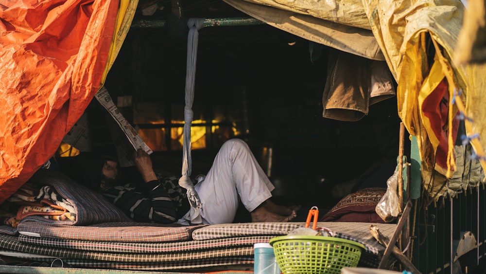 a man laying on a bed under a canopy