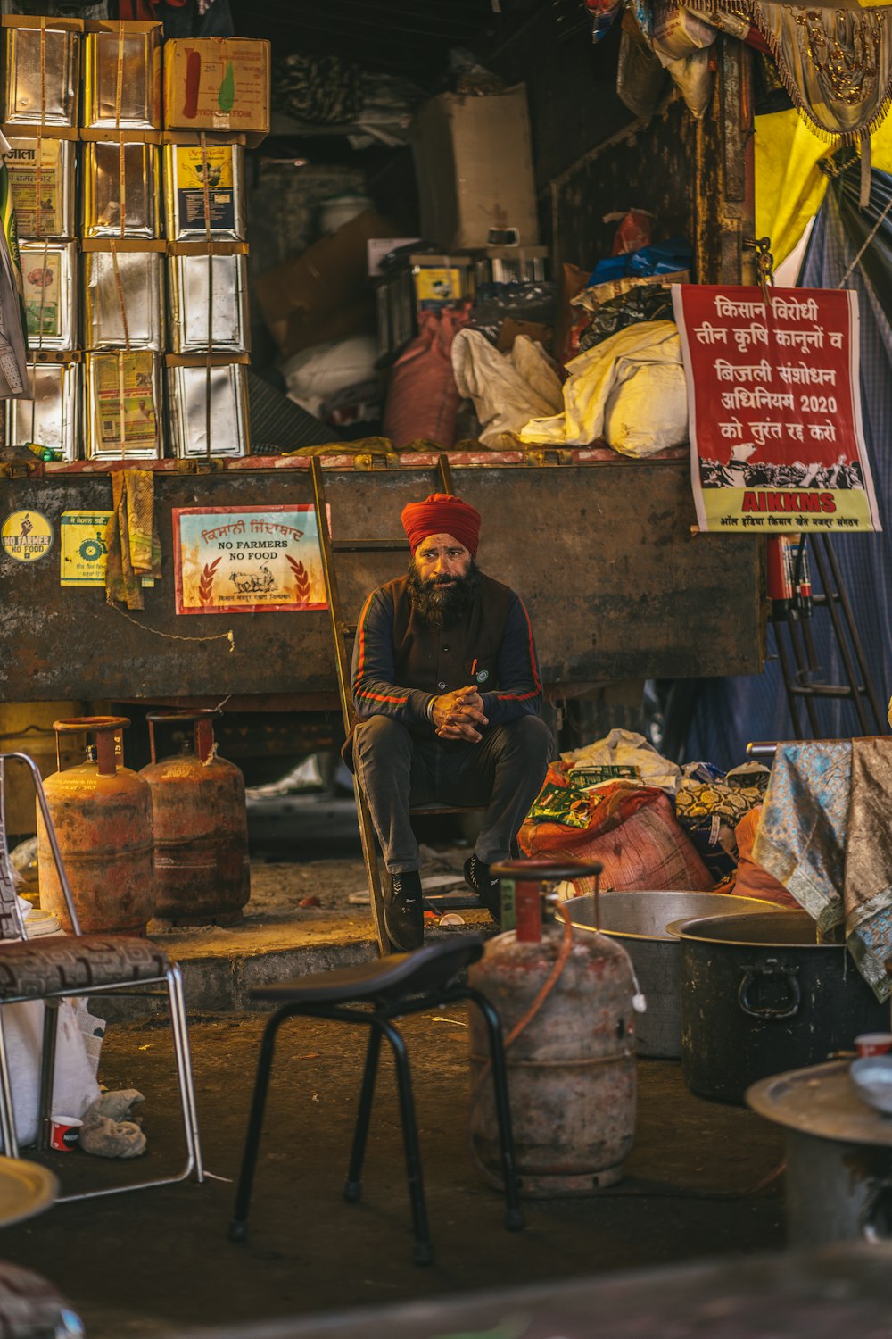 a man sitting on a chair in a market